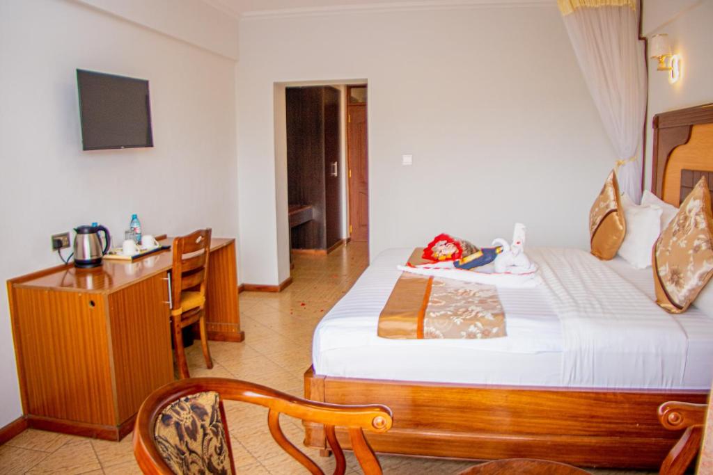 Postel nebo postele na pokoji v ubytování Grand Winston Hotel