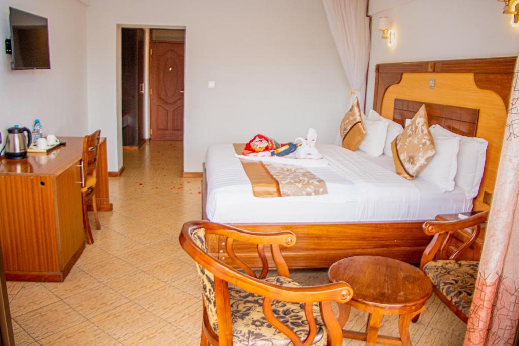 Postel nebo postele na pokoji v ubytování Grand Winston Hotel