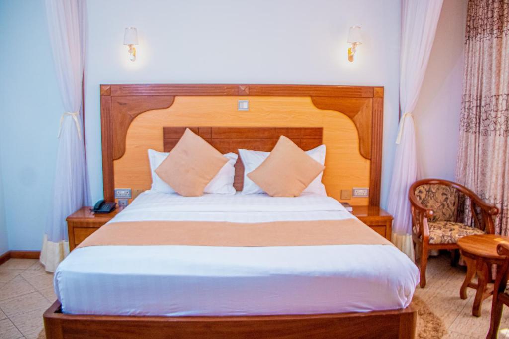 Postel nebo postele na pokoji v ubytování Grand Winston Hotel