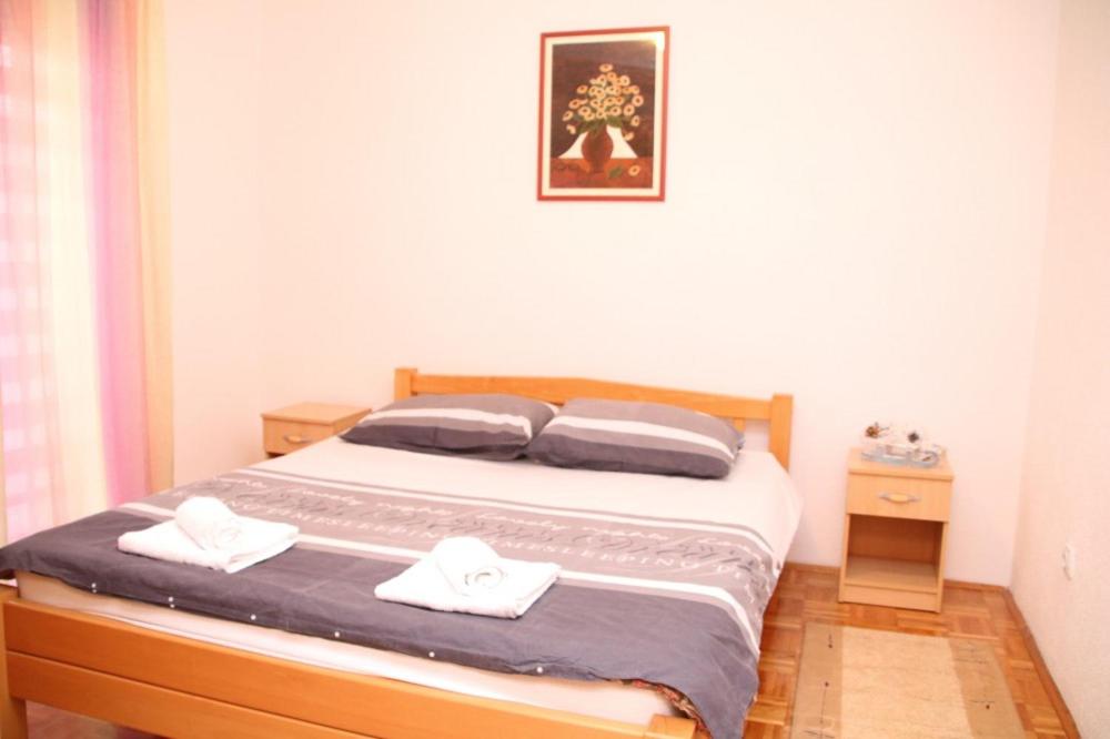 a bedroom with a bed with two towels on it at Apartman Vuvuzela in Kupres