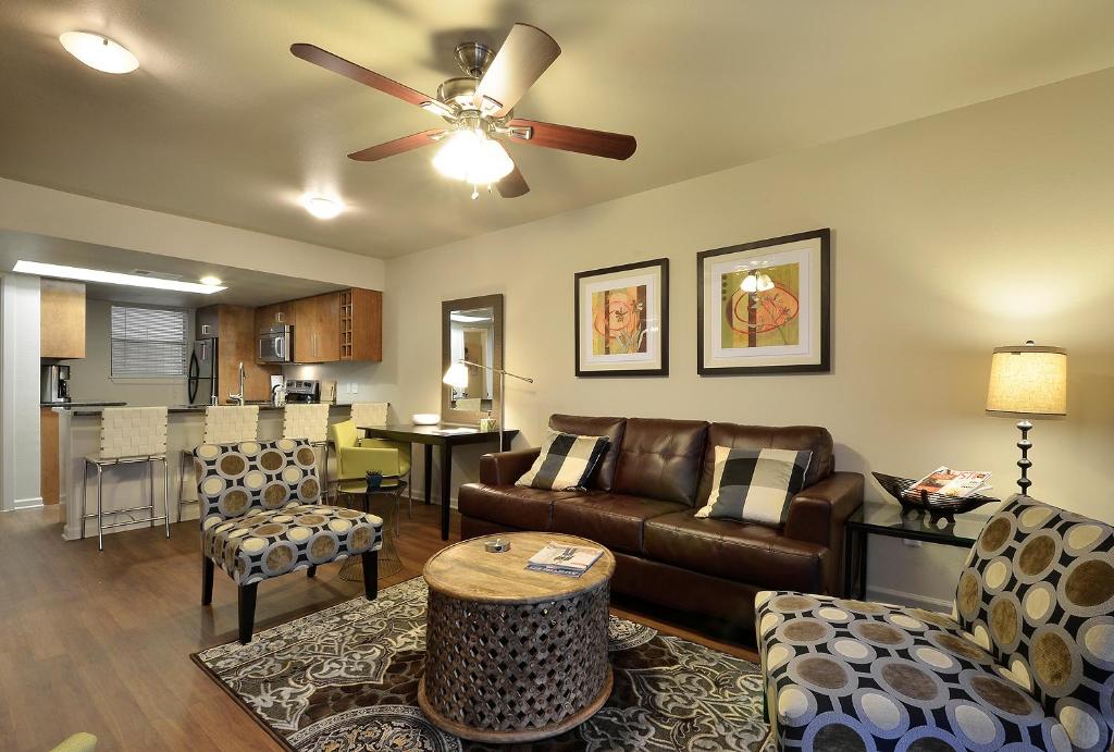 a living room with a couch and a table at The Norwalk by Lodgewell - West Austin Three's Company Vibes in Austin