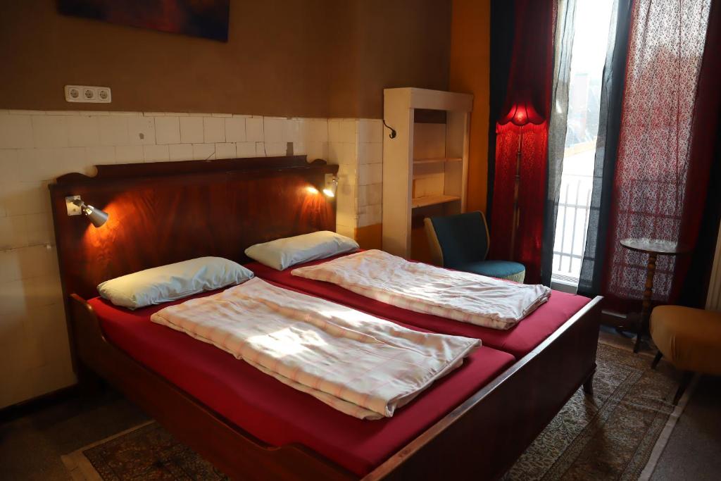 a bedroom with a large bed with a wooden headboard at schickSAAL* in Lübeck