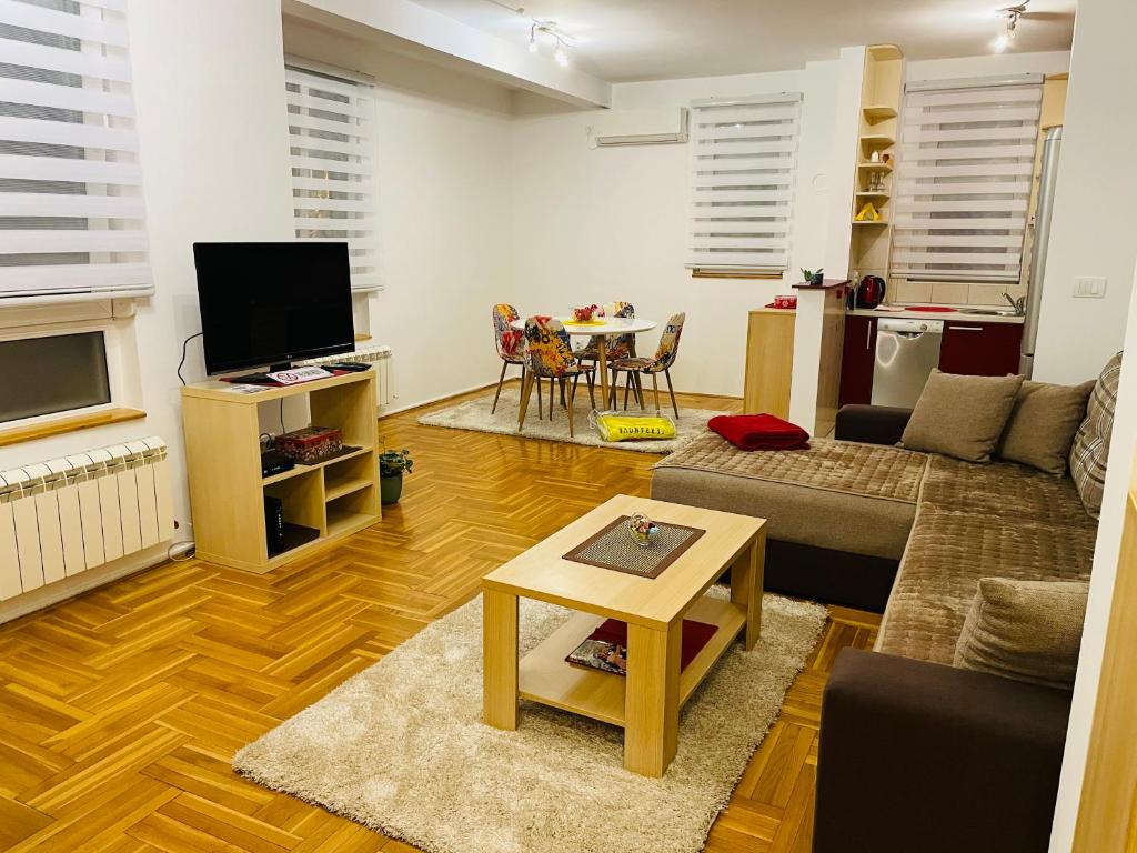 a living room with a couch and a table at Jolly Apartment - Belgrade in Belgrade