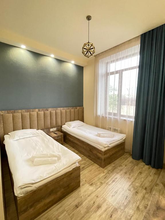 um quarto com duas camas e uma janela em Glendale Boutique Hotel em Yerevan