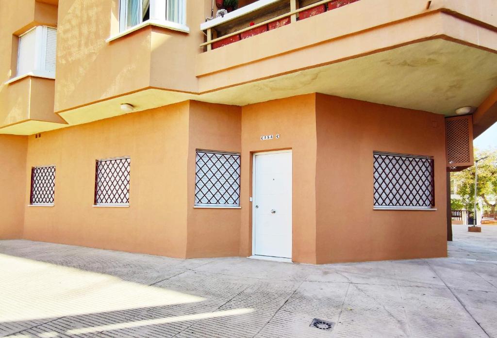 un bâtiment avec une porte blanche sur son côté dans l'établissement APARTAMENTOS SANLUCAR CASA C, à Sanlúcar de Barrameda