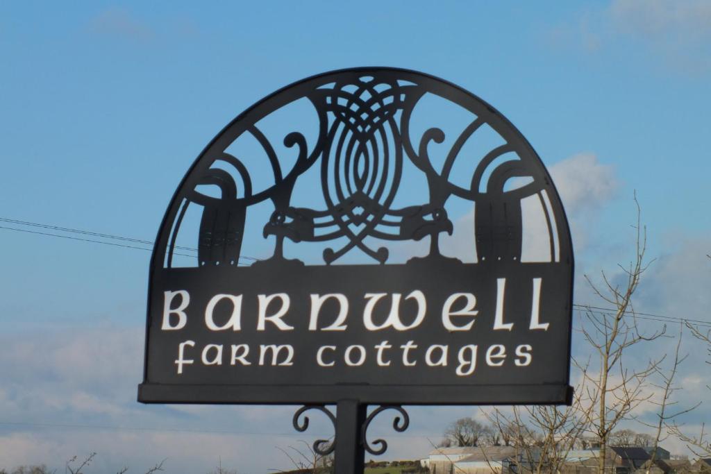 a sign for a farmersfw farmercemeteryemetery at Barnwell Farm Cottages Corn cottage in Greyabbey