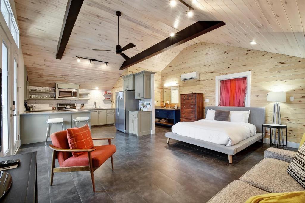 a large bedroom with a bed and a kitchen at The SoCo Studio by Lodgewell - 2 cute 2 b 4 gotten in Austin