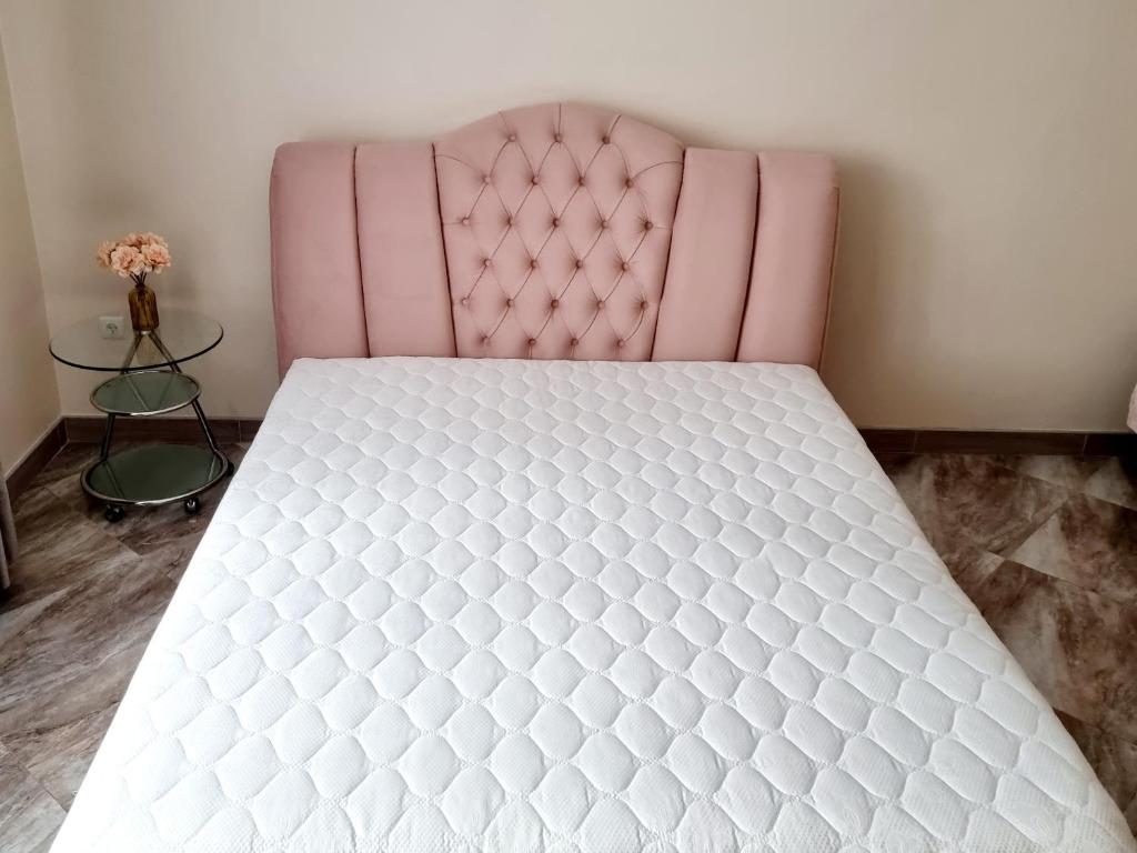 a bed in a room with a pink bed frame at Forrest for 8 person in Luts'k