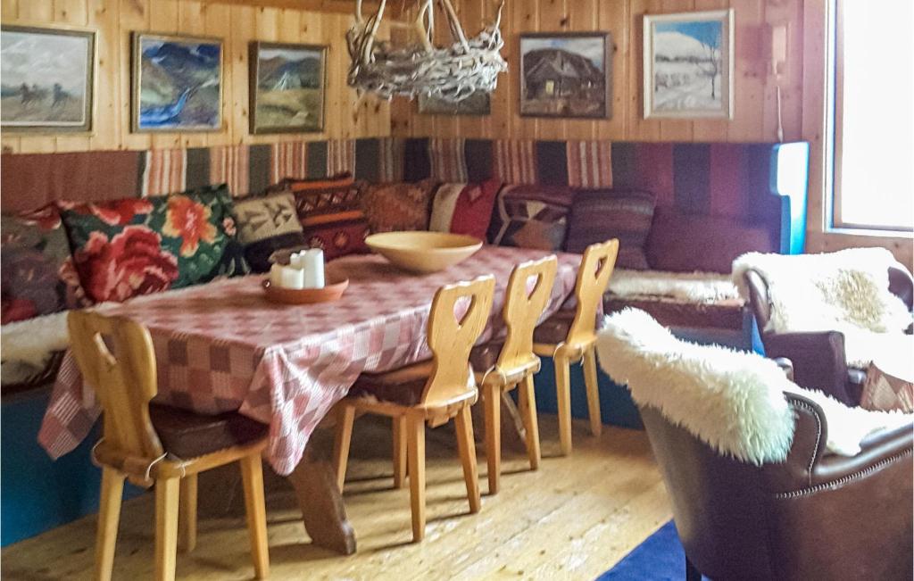 a dining room with a table and chairs and a couch at Lovely Home In Vemdalen With Sauna in Vemdalen