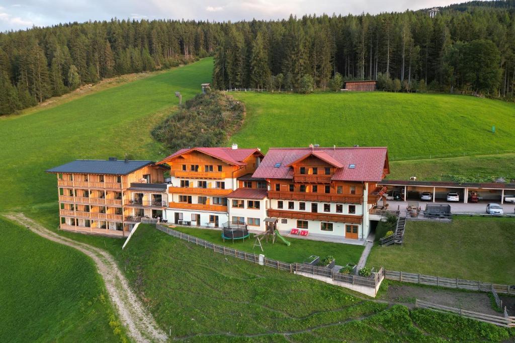 an aerial view of a large building in a field at Hotel Breilerhof in Schladming