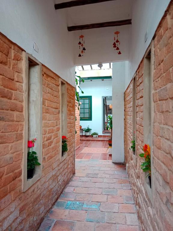 a corridor of a building with a brick wall at CASA DE LOURDES - LA CANDELARIA in Bogotá