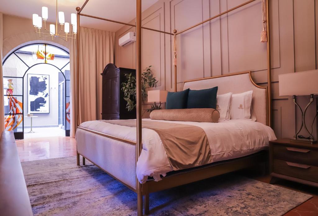a bedroom with a large bed with a wooden frame at Hotel Boutique Corazón Mexicano in Guanajuato