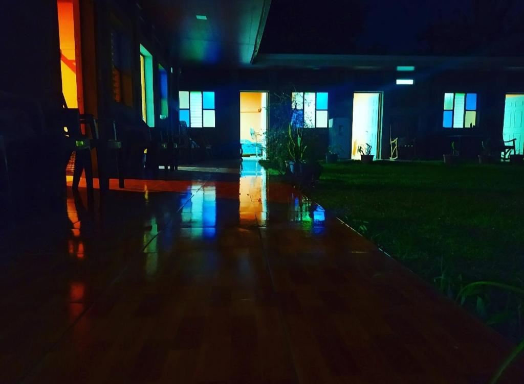 an empty house with lights on the floor at night at Rustic House Hostel in Moyogalpa