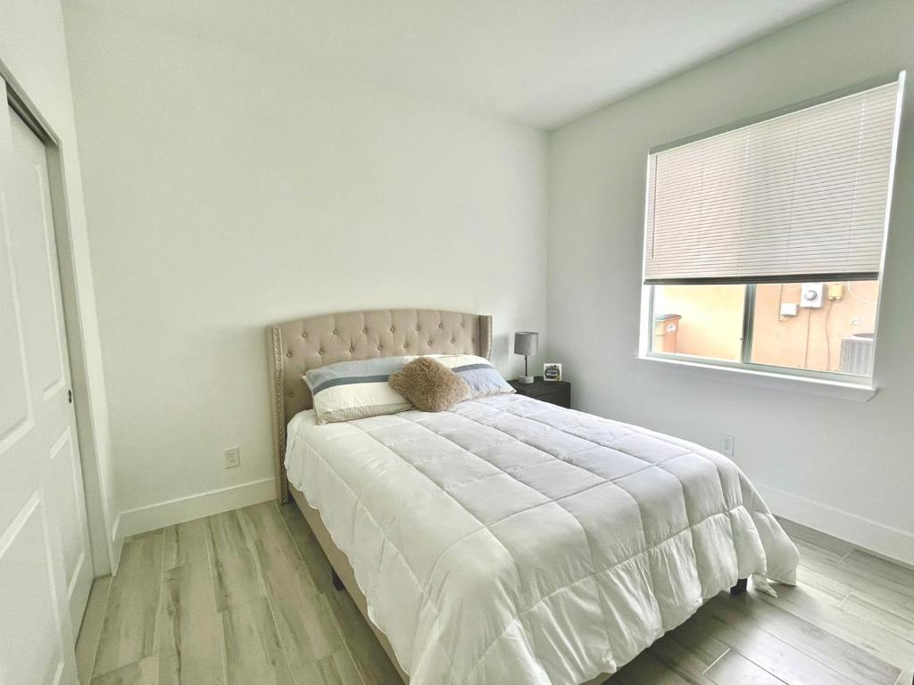 a bedroom with a large bed with a window at New house with canal view in Cape Coral in Cape Coral