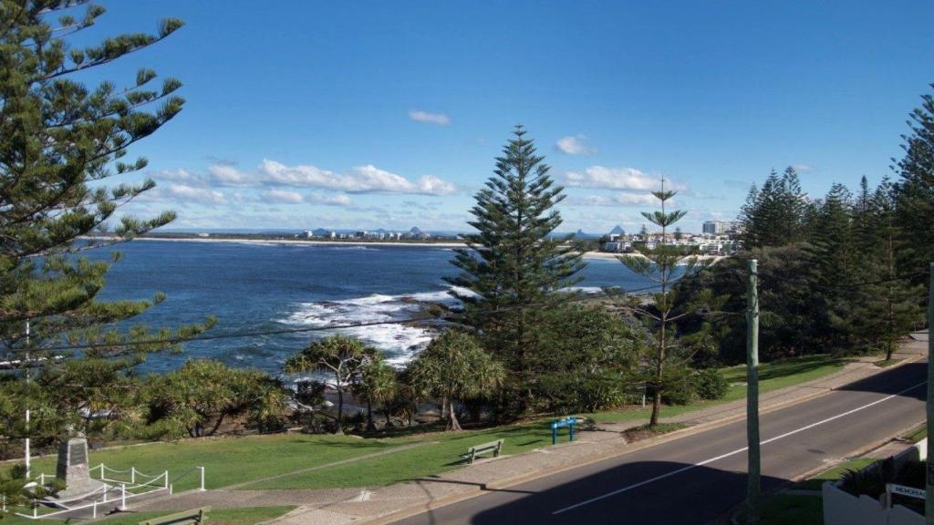 a view of the ocean with a street and trees at Wickham Point Unit 4 Kings Beach QLD in Caloundra
