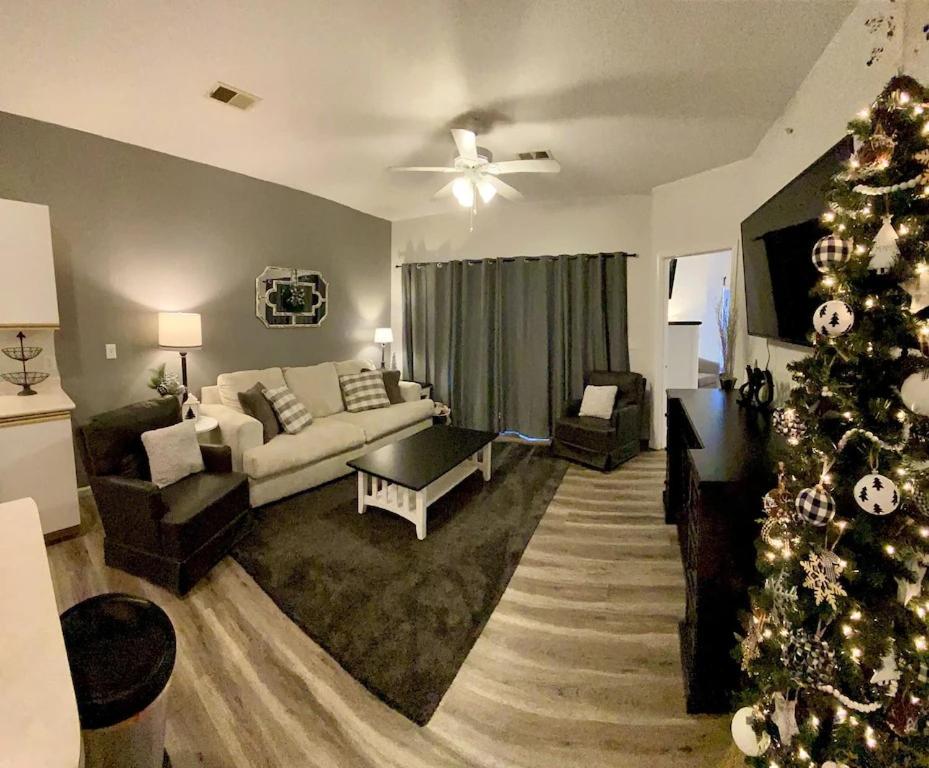 a living room with a christmas tree in it at Sunago Suites in Branson