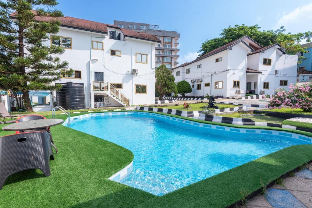 a swimming pool in the yard of a building at The Winford Boutique Hotel Airport in Accra