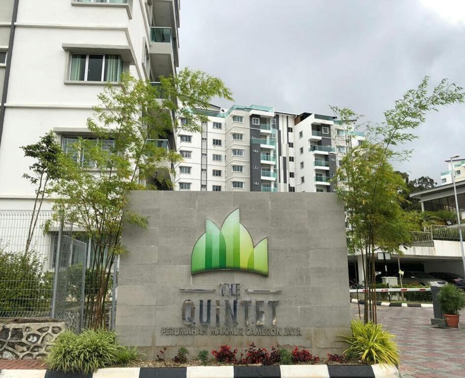 a sign in front of a building at Quintet Aparment in Tanah Rata