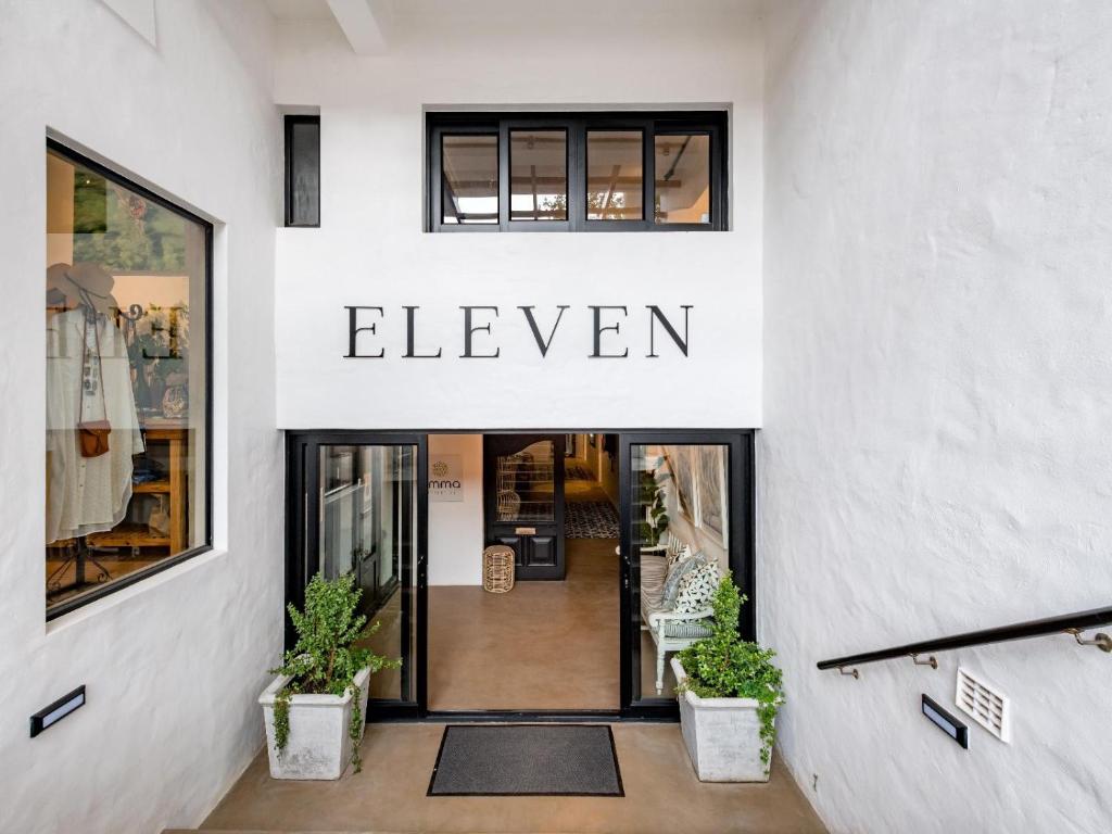 a store entrance with a sign that reads eleven at Eleven in Plettenberg Bay