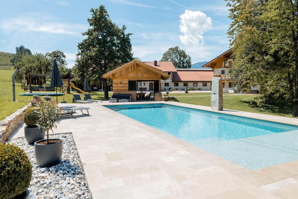 a swimming pool in front of a house at Ferienparadies Taxen in Sankt Veit im Pongau