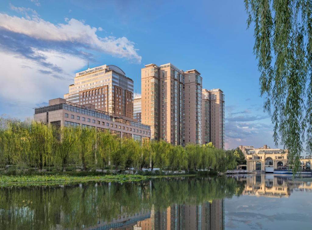 une ligne d'horizon avec de grands bâtiments et une masse d'eau dans l'établissement Four Seasons Hotel Beijing, à Pékin