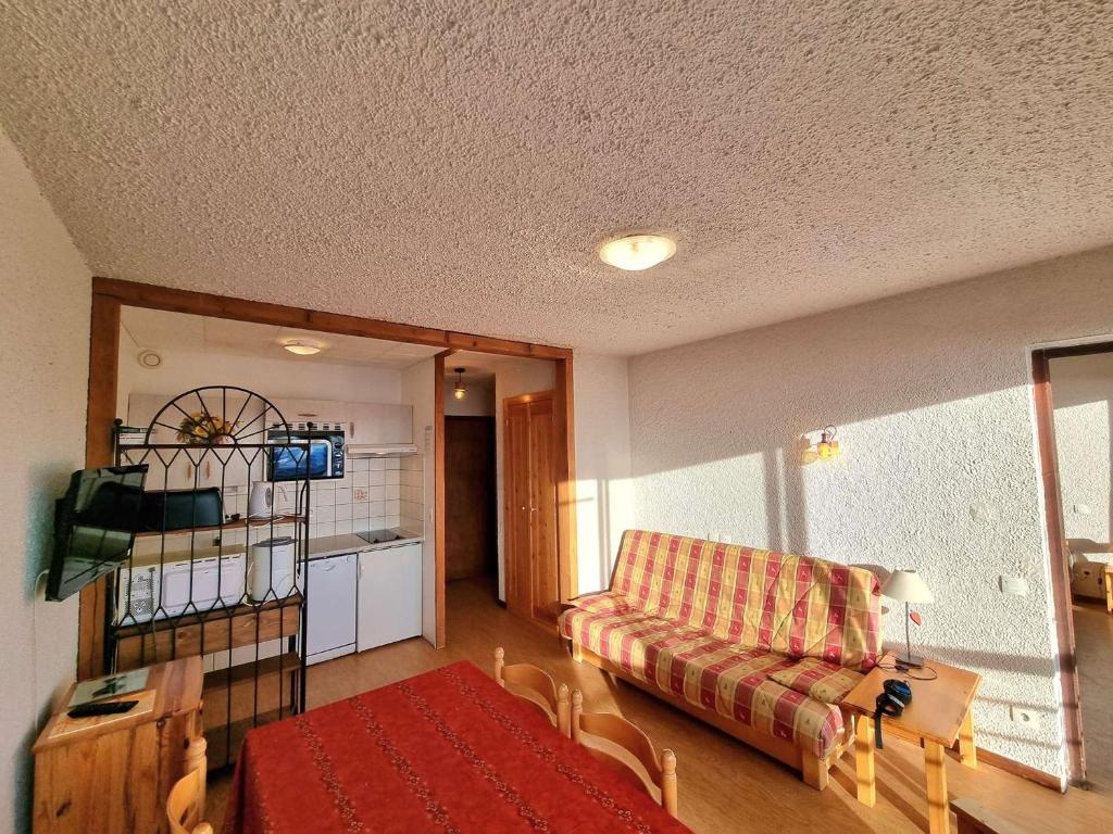 a living room with a couch and a table at Appartement Saint-Michel-de-Chaillol, 2 pièces, 6 personnes - FR-1-393-87 in Saint-Michel-de-Chaillol