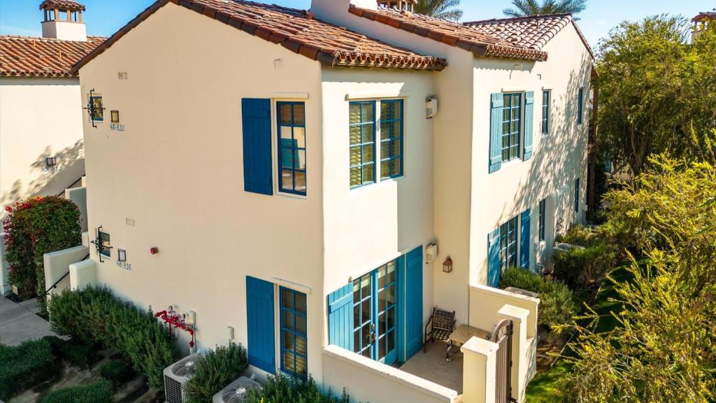 een luchtzicht op een wit huis met blauwe luiken bij LV203 Downstairs 2 Bedroom Villa Near Main Pools in La Quinta