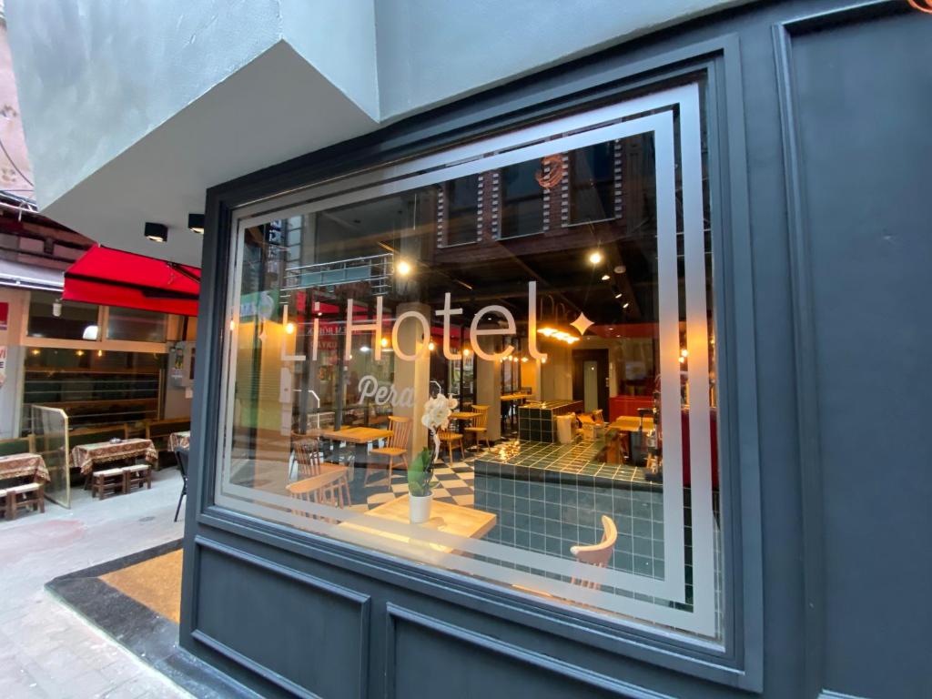 a window of a restaurant with a sign that reads cafe at Li Hotel Pera in Istanbul
