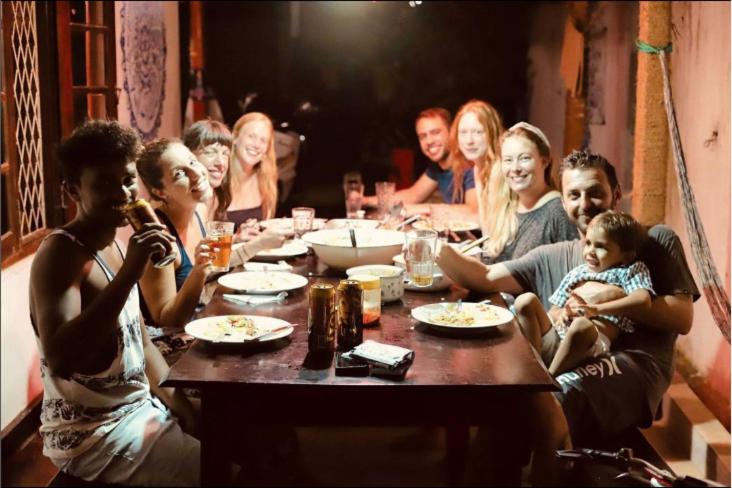 a group of people sitting around a table at Hostel Singha Lounge in Unawatuna