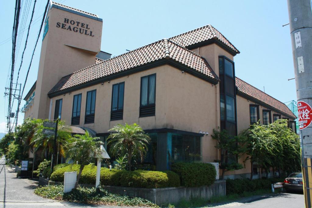 a building with a sign for a hotel recently at Hotel Seagull in Izumi-Sano