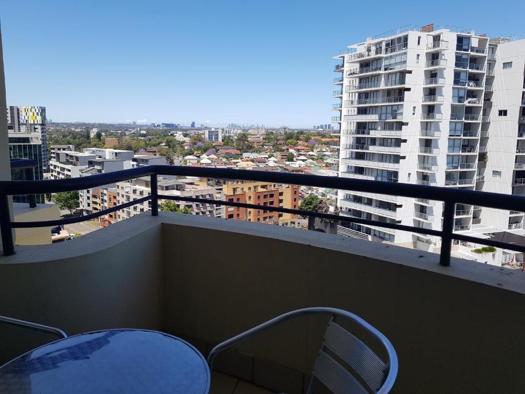 a balcony with a view of a city at Parramatta Hotel Apartment in Sydney