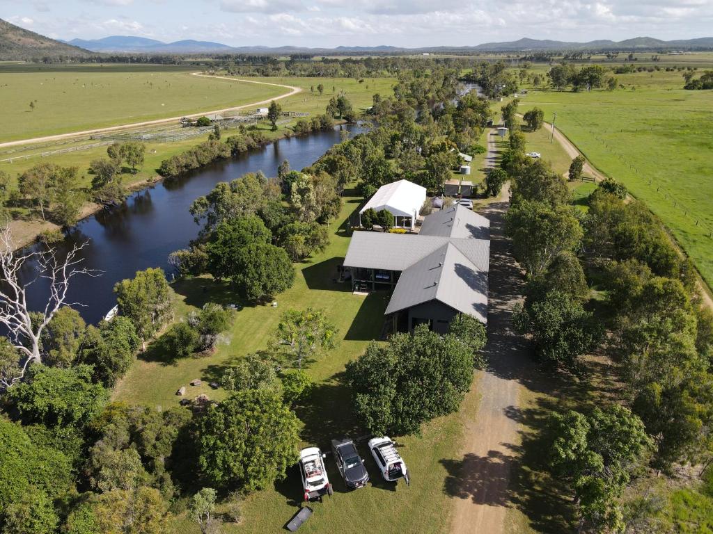 an aerial view of a building next to a river at Hedlow Retreat in Barmoya