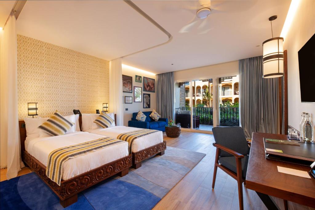 Postel nebo postele na pokoji v ubytování The Mora Zanzibar - Luxury All Inclusive