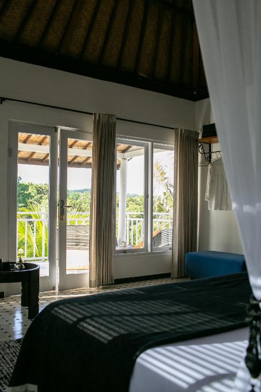 Postel nebo postele na pokoji v ubytování Segredo Uluwatu