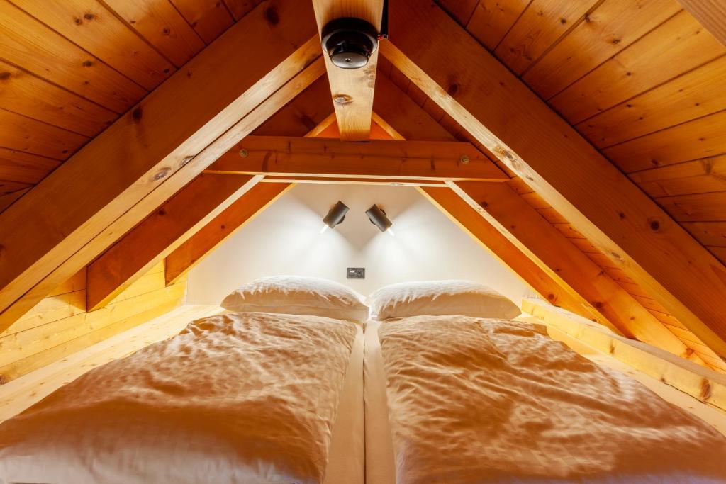 a room with two beds in a attic at Sonne Andermatt Swiss Quality Hotel in Andermatt