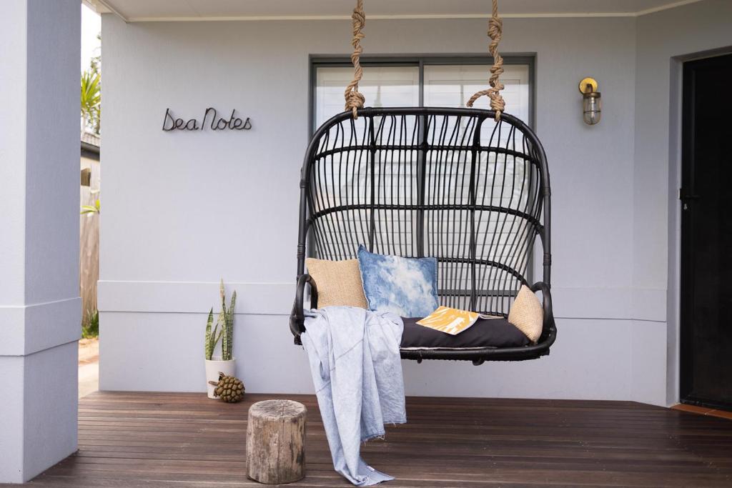 a swing in the living room of a house at Sea Notes Yamba in Yamba