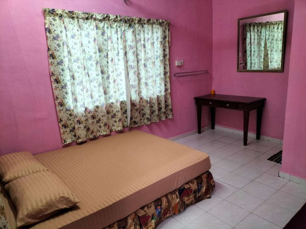 una camera con un letto con una finestra e un tavolo di Iman D'Semungkis Resort & Training Center Hulu Langat a Hulu Langat