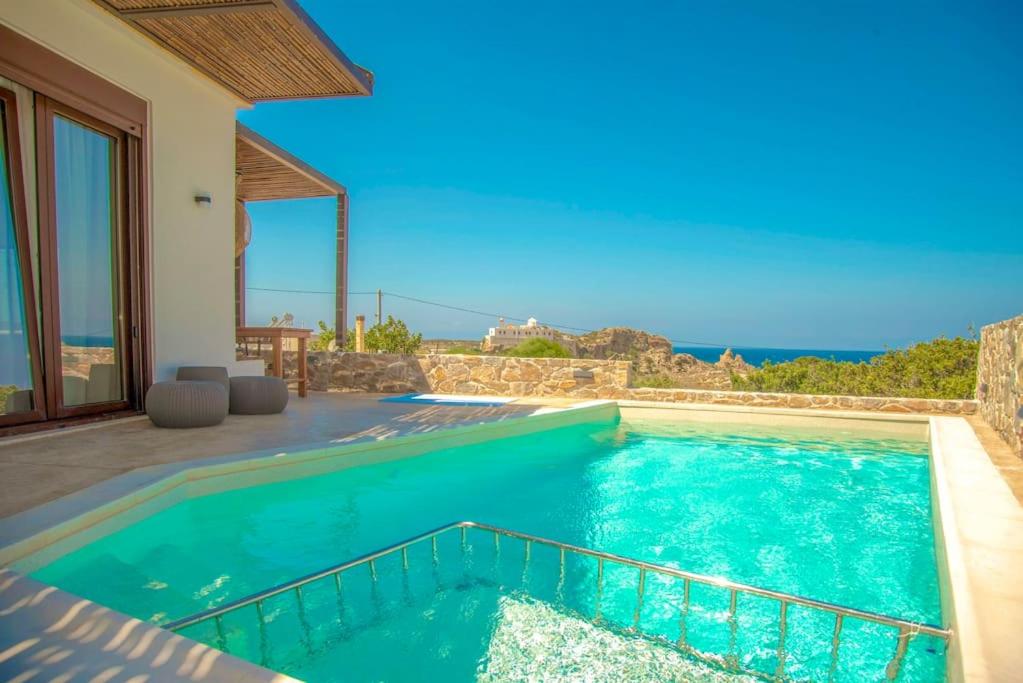 a swimming pool in a villa with a view of the ocean at Sia Elafonisi Pool House in Elafonisi