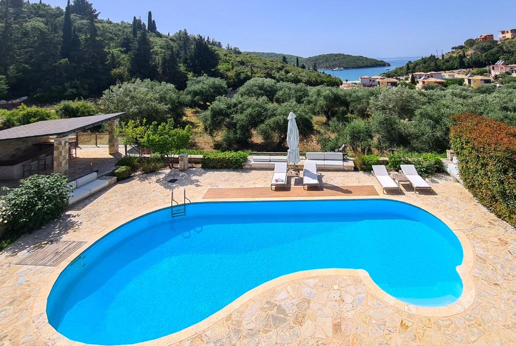 a swimming pool in the middle of a resort with a view at SAZ VILLAS in Syvota