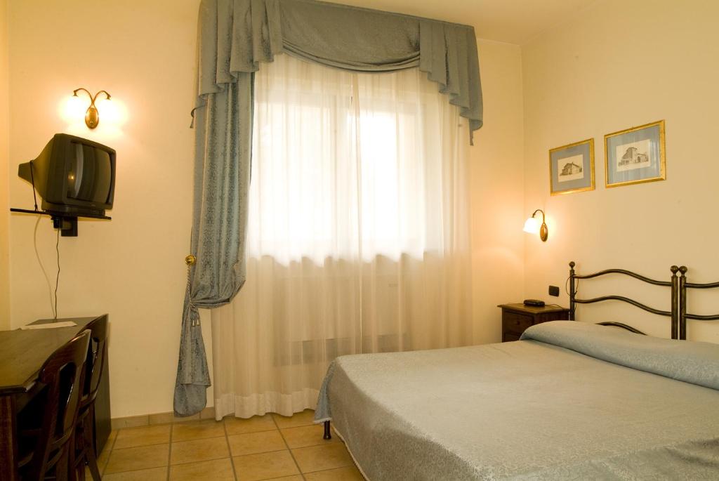 Postel nebo postele na pokoji v ubytování Dominus Hotel