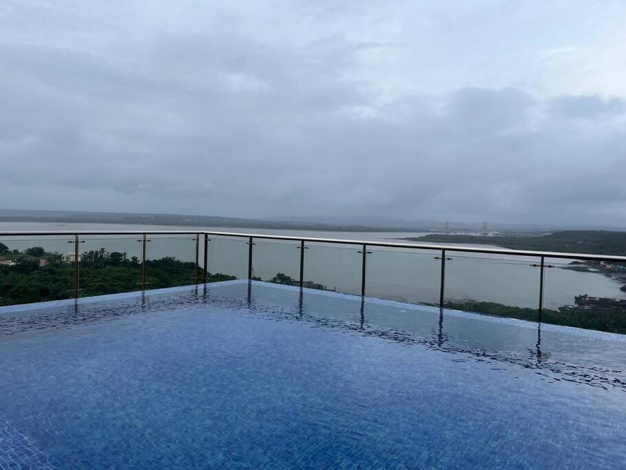 a view of a body of water from a balcony at Studio Apt with Rooftop Panoramic views @ Dabolim in Vasco Da Gama
