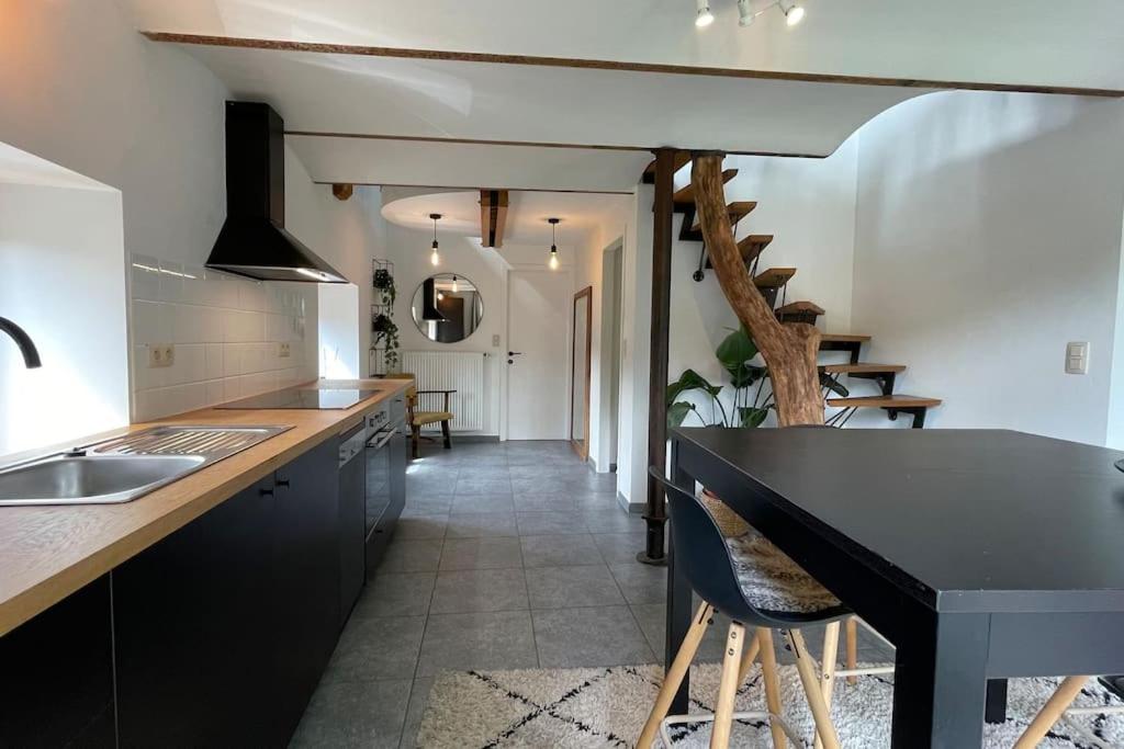 a kitchen with a black counter top and a sink at Le Belle-Vue in La Roche-en-Ardenne