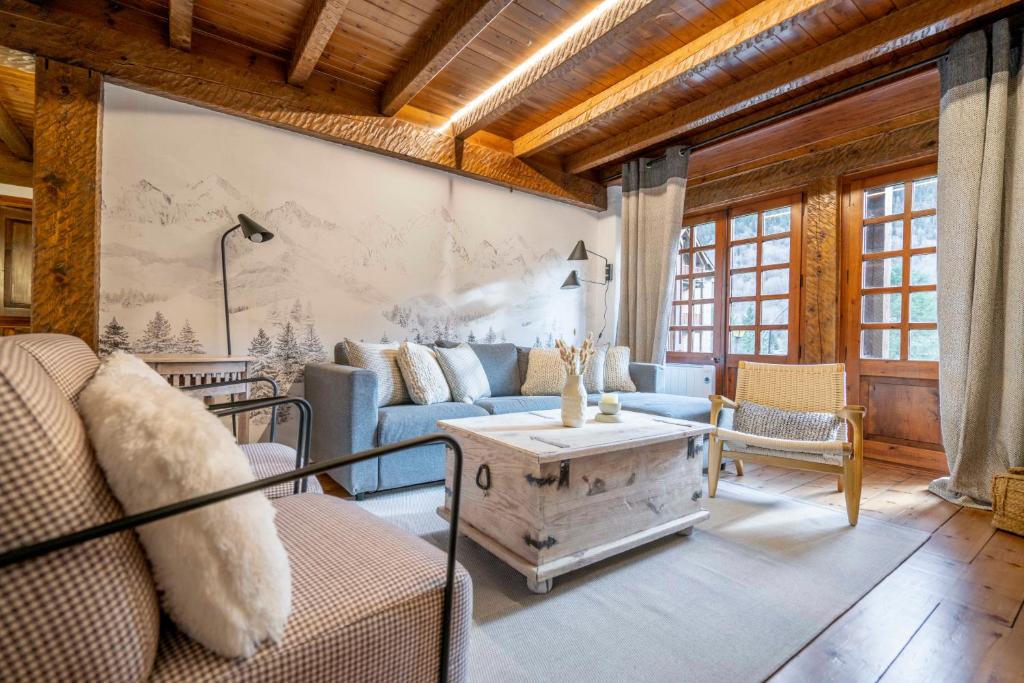 a living room with a couch and a table at Casa Baciver by FeelFree Rentals in Garós