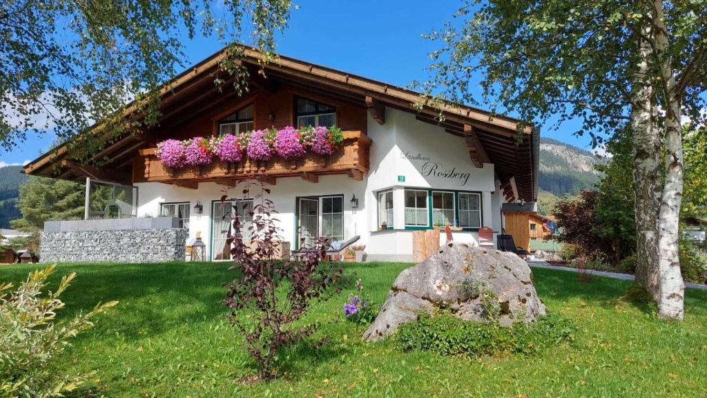 une maison avec des fleurs à l'avant dans l'établissement Landhaus Rossberg, à Tannheim