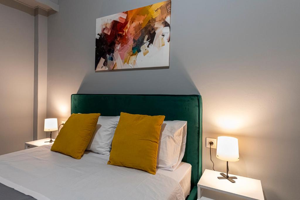 A bed or beds in a room at Athenian center apartments