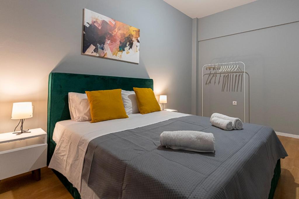 A bed or beds in a room at Athenian center apartments