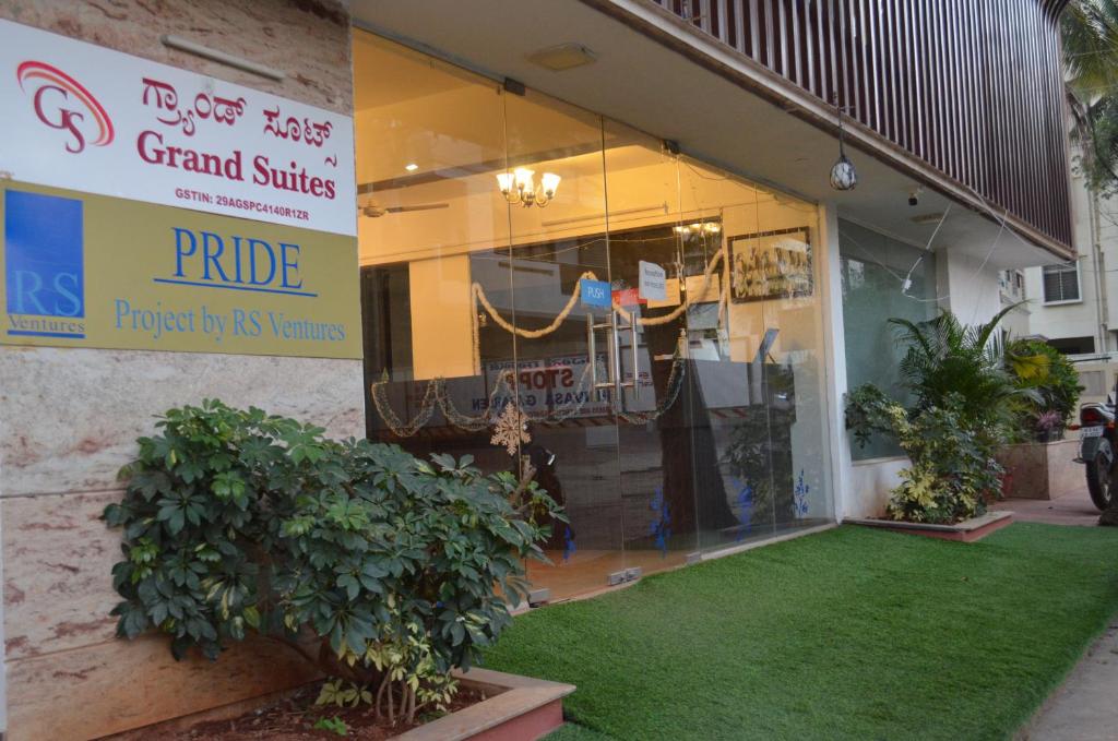 a store front with a green lawn in front of it at Grand Suites Yelahanka in Bangalore