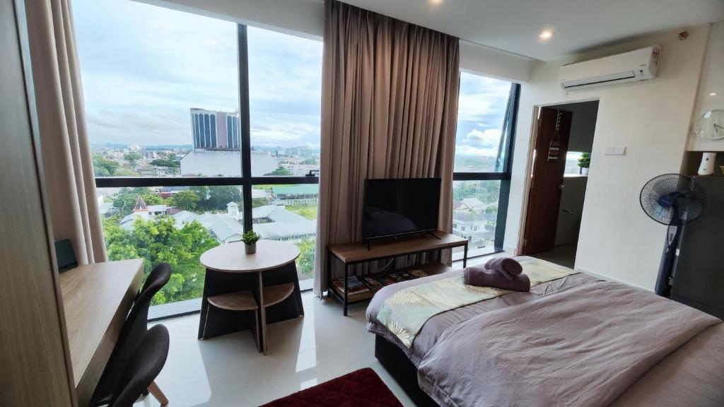 een slaapkamer met een bed en een groot raam bij Comfy Studio Kuching in Kuching