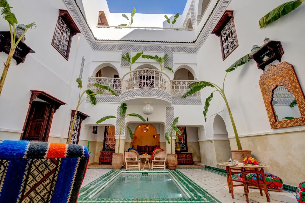 a villa with a swimming pool in the middle of a building at Riad MedJad & Spa in Marrakech