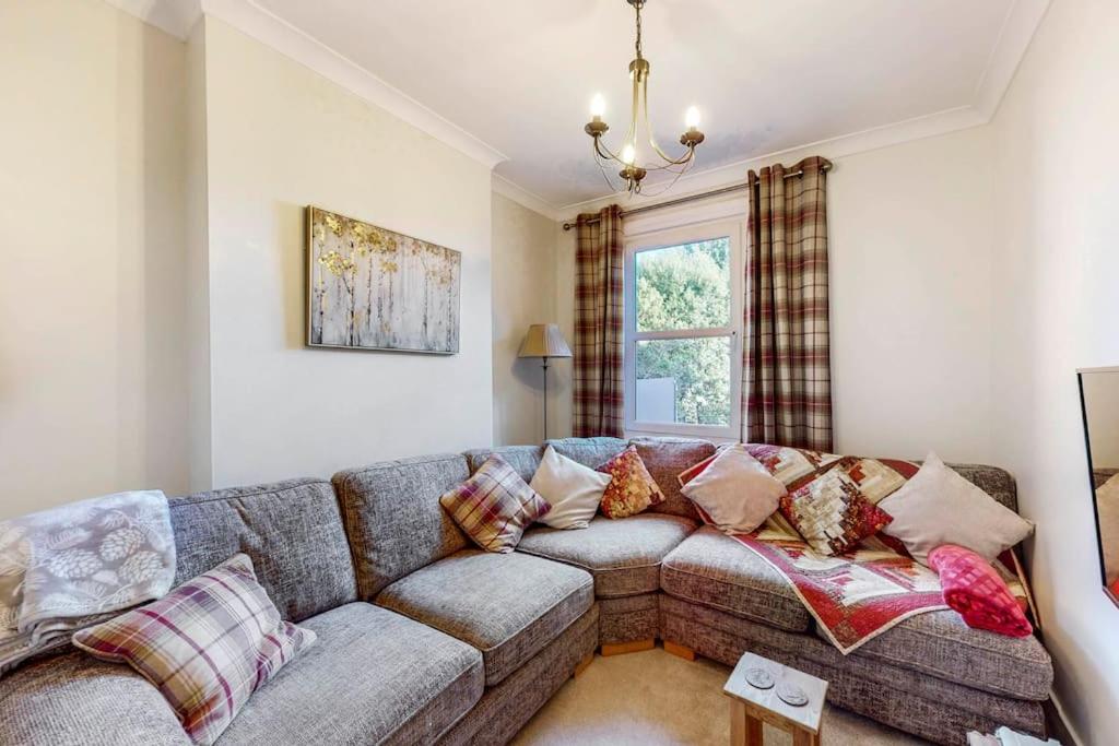 uma sala de estar com um sofá e uma janela em Beautiful two bedroom apartment in Honor Oak em Londres